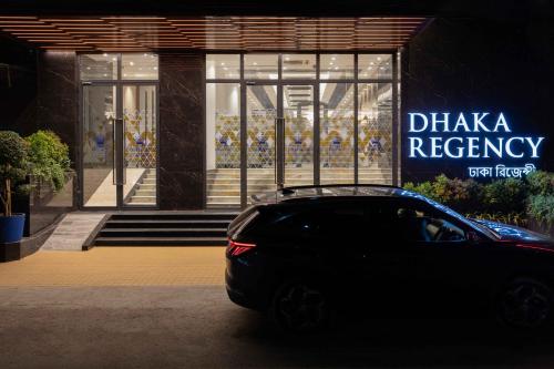 a black car parked in front of a store at Dhaka Regency Hotel & Resort Limited in Dhaka