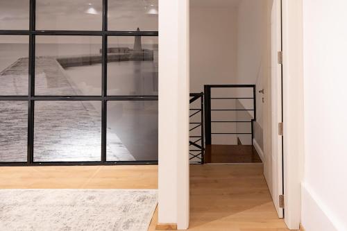 a room with a large window and a staircase at Florette Suite 1BR with Stunning Lounge Terrace by ArcoBnb in Il-Furjana
