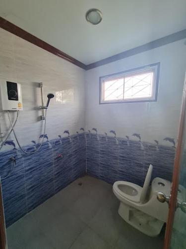 a bathroom with a toilet and a window at ทรัพย์แม่หนุน 