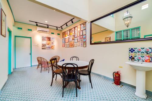 a room with a table and chairs and a sink at Dream & Wander Homestay in Ipoh