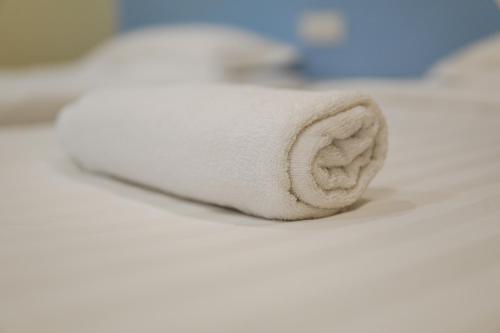 a roll of white toilet paper sitting on a bed at Dream & Wander Homestay in Ipoh