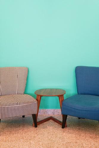 two chairs and a table and a chair and a table at Dream & Wander Homestay in Ipoh