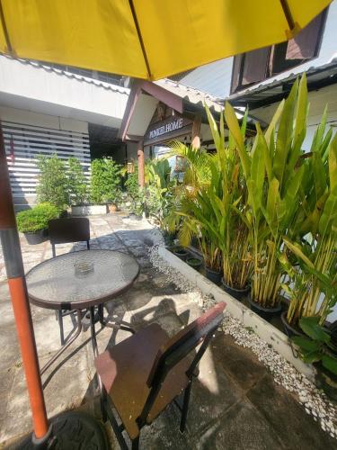 a patio with a table and chairs and plants at Punkei home-Chiang Mai Center Near Sunday Market in Chiang Mai