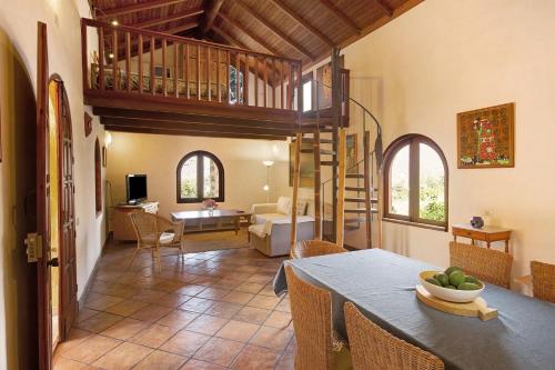 a living room with a dining table and a living room at Finca Los Dioses I in Mogán