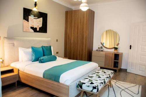 a bedroom with a large bed and a mirror at Blueberry Villas in Eldoret