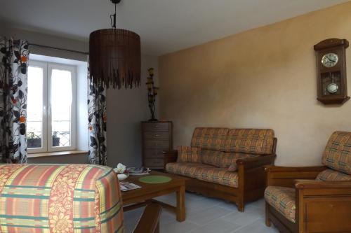 a living room with a couch and a chair at Gîte du Toilier in Thillot-sous-les-Côtes