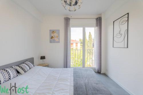 a white bedroom with a bed and a window at Modernity & Comfort Downtown Aix en Provence in Aix-en-Provence