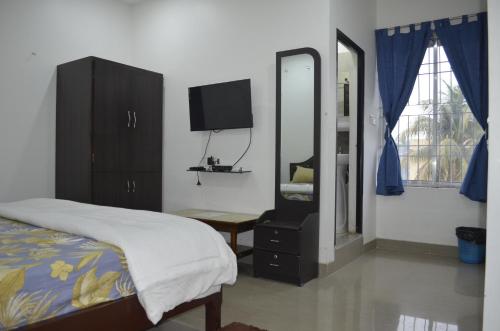 a bedroom with a bed and a mirror and a dresser at HOTEL MOON-LITE in Guwahati