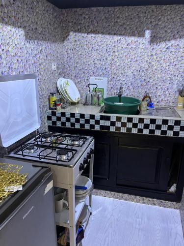 a kitchen with a stove and a counter top at Chez Astrid in Yaoundé
