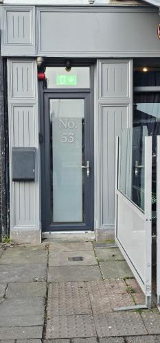 a door of a store with a no smoking sign on it at 53 Luxury Rooms in Maynooth