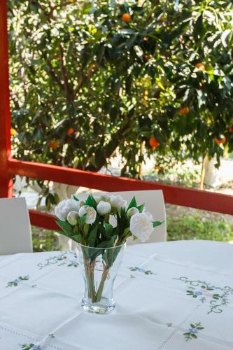 a vase of white flowers sitting on a table at CottonClub Villas in Tolo