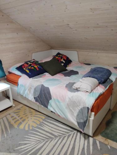 a bed with pillows on it in a room at Dom nad wodospadem in Kletno