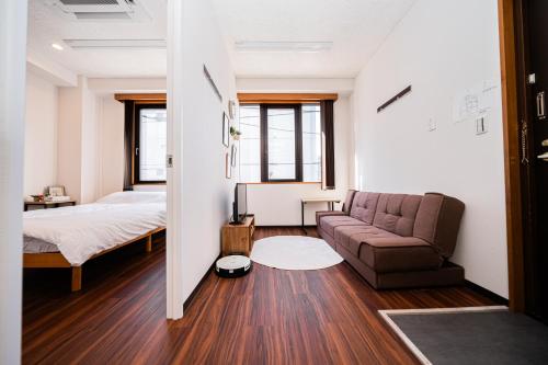 a living room with a bed and a couch at Skytree Apartment Self Check-in in Tokyo