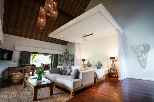 a living room with a couch and a table at Pondok Santi Estate in Gili Trawangan