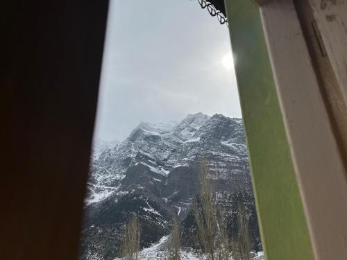 a view of a snow covered mountain from an airplane window at SNOWFLAKE Homestay in Gondla