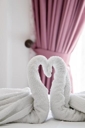 a pile of towels sitting next to a pile of towels at Ruellia Luxury Apartments in Lefkada Town