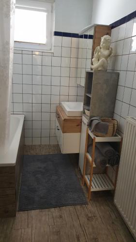 a small bathroom with a tub and a sink at Casa Claudia in Liezen