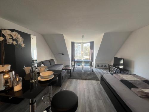 a bedroom with a bed and a living room at City-Apartment in Wuppertal