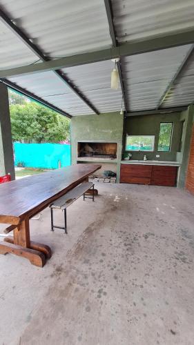 an empty room with a large wooden table in it at Cabaña LA JUANA in Villa Anizacate