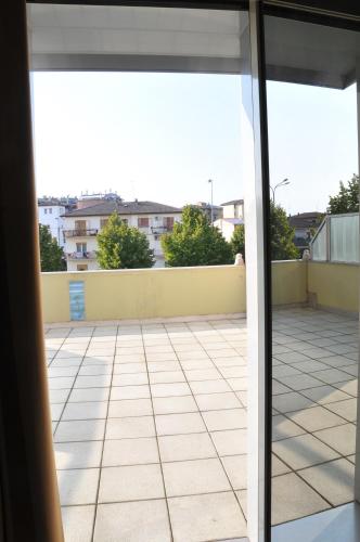 a view from an open glass door of a patio at Hotel Verdi in Vicenza