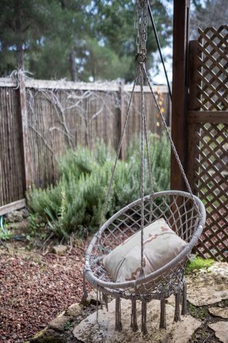 a swing with a pillow in a yard at Gate Away B&B Units - המקום באל רום in El-Rom