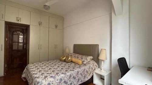 a bedroom with a bed with a gold decoration on it at Tranquilidade in Rio de Janeiro