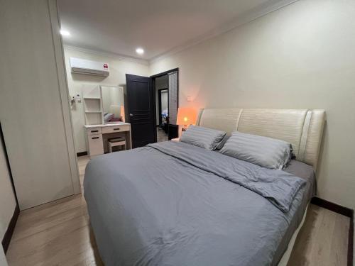 um quarto com uma cama grande e uma cozinha em Riverbank Suite @ Waterfront KCH em Kuching