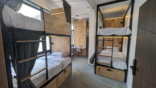 two bunk beds in a room with a mirror at Urban Jungle Hostel in Bangkok