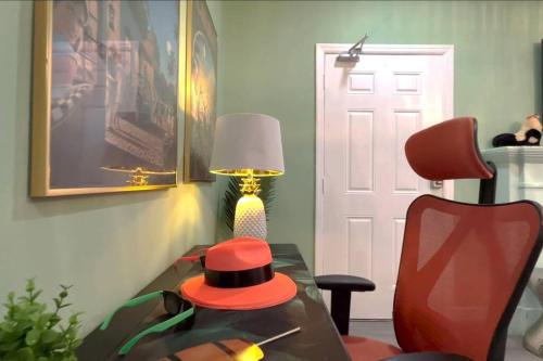 a room with a table with a red hat on it at NEW! Havana Nights Villa ! Walk to Calle Ocho! in Miami
