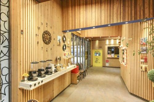 a store hallway with wooden walls and a counter with pots and pans at Dorothy Hotel in Cheonan