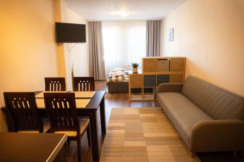 a living room with a couch and a table at IG Apartments Royal Towers 426 in Bansko