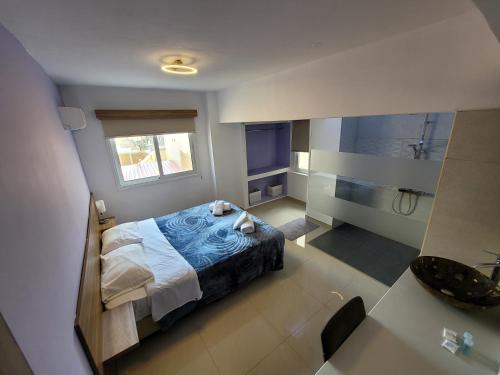 a bedroom with a bed and a bathroom with a shower at Palm Sea Suite 17 in Larnaca