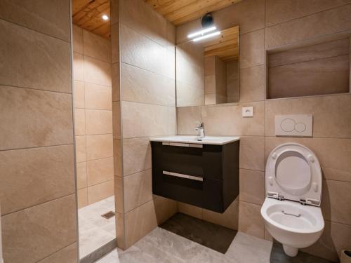 a bathroom with a toilet and a sink and a mirror at Bel Appartement 3 Pièces avec Balcon, Proche Centre Châtel, Parking et Connexion WiFi - FR-1-676-119 in Châtel