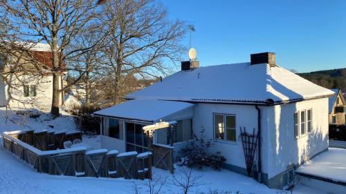 a white house with snow on the roof at Storgatan 82 Virserum in Virserum