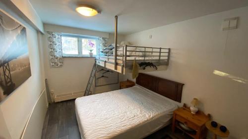 a small room with a bed and a staircase at Storgatan 82 Virserum in Virserum