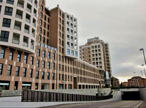 a group of tall buildings in a city at Tiny House Tower in Fidenza