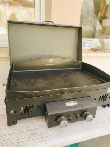 an old stove sitting on top of a table at Emplacement idéal dans le Var ! in Cuers