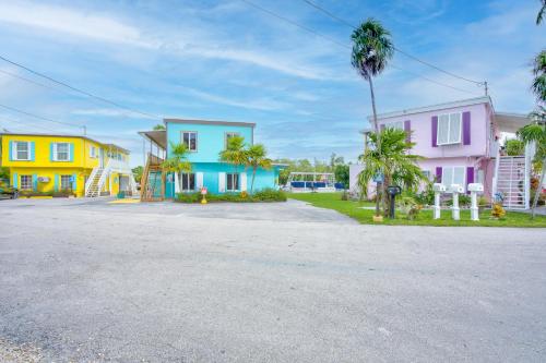 a row of houses with palm trees in a street at Captain Pip's Marina & Hideaway in Marathon
