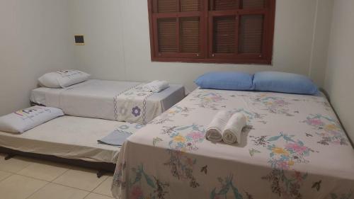duas camas num quarto com toalhas em Alma leve! em Florianópolis