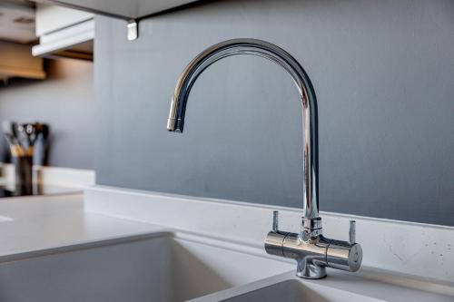 a kitchen sink with a chrome kitchen faucet at Apt 4 North Marine Villa in Scarborough