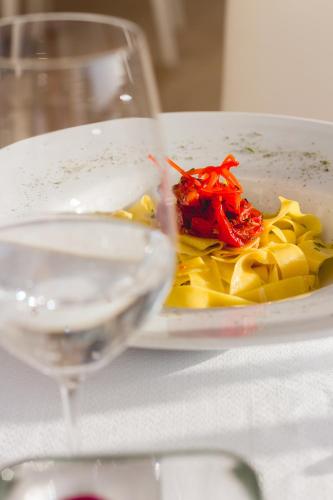 a plate of food next to a glass of wine at DCO Suites Lounge & Spa in Máncora