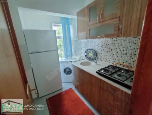 a small kitchen with a stove and a refrigerator at Furnished Apartment [Mounthly Discount] D4 in Antalya