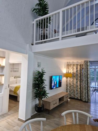 a living room with a tv on a wall at 44 Montego Bay Caribbean Estates in Port Edward