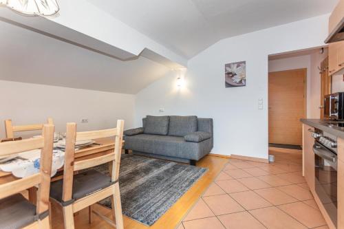 a living room with a couch and a table at Ferienwohnungen Lahner in Bramberg am Wildkogel