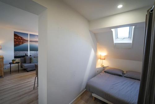 a bedroom with a bed and a living room at L'appartement Lafayette in Annecy