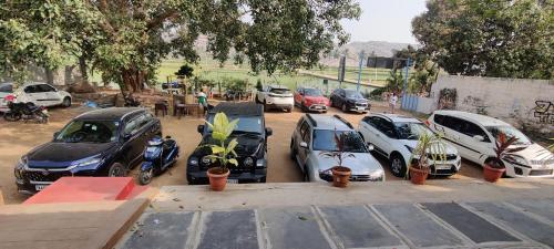 a bunch of cars parked in a parking lot at Jungle Tree Hampi in Hampi