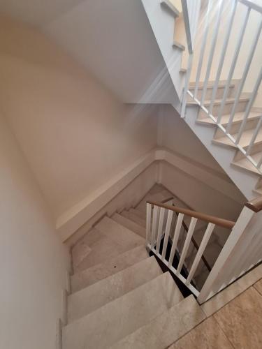 a staircase in a house with a white stair case at Hostal Pension - La Rotonda in Tardienta