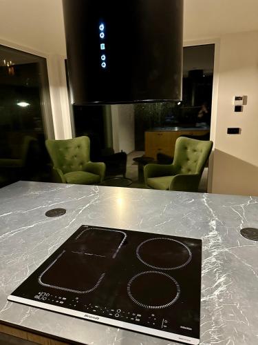 a laptop sitting on a counter in a room at Residence Smržovka - Luxury House with Swimming Pool, Jacuzzi, Garden and BBQ in Jablonec nad Nisou