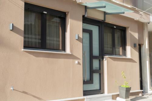 a front door of a house with a potted plant at Anastasia's Luxury House in Kavala