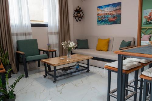 a living room with a couch and a table and chairs at Anastasia's Luxury House in Kavala